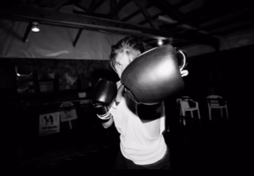 Black and white photo of Sydney Sweeney boxing.