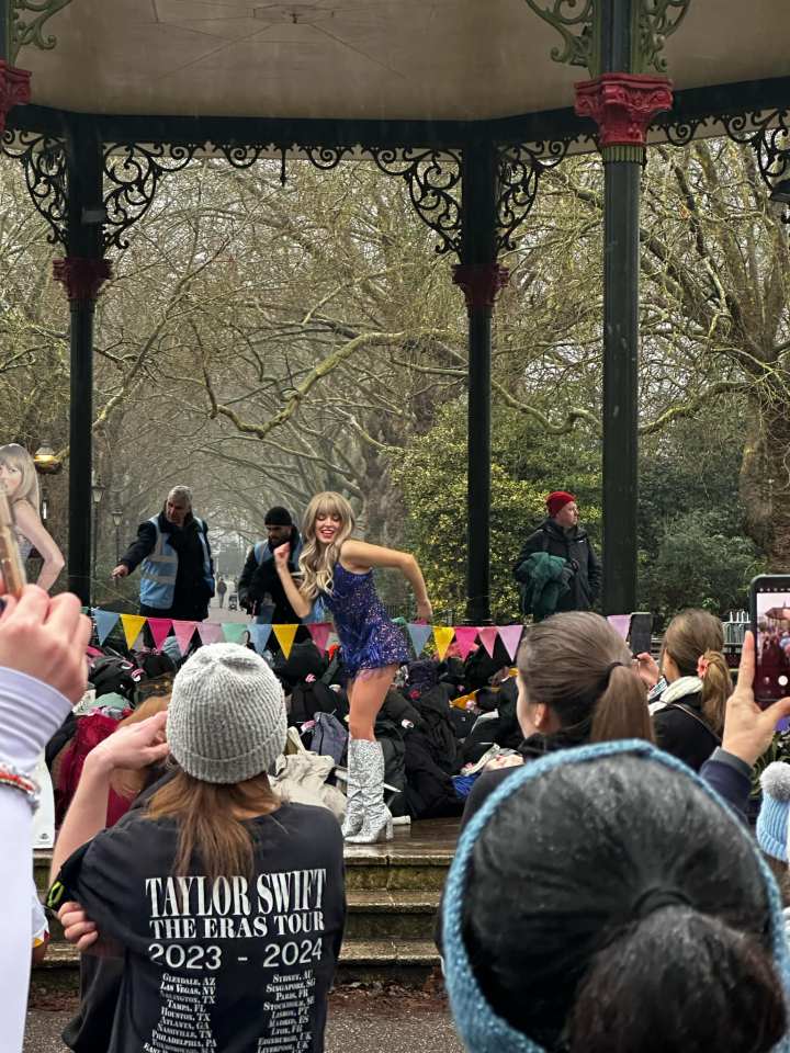 Woman in sparkly outfit performing at a Taylor Swift fun run.