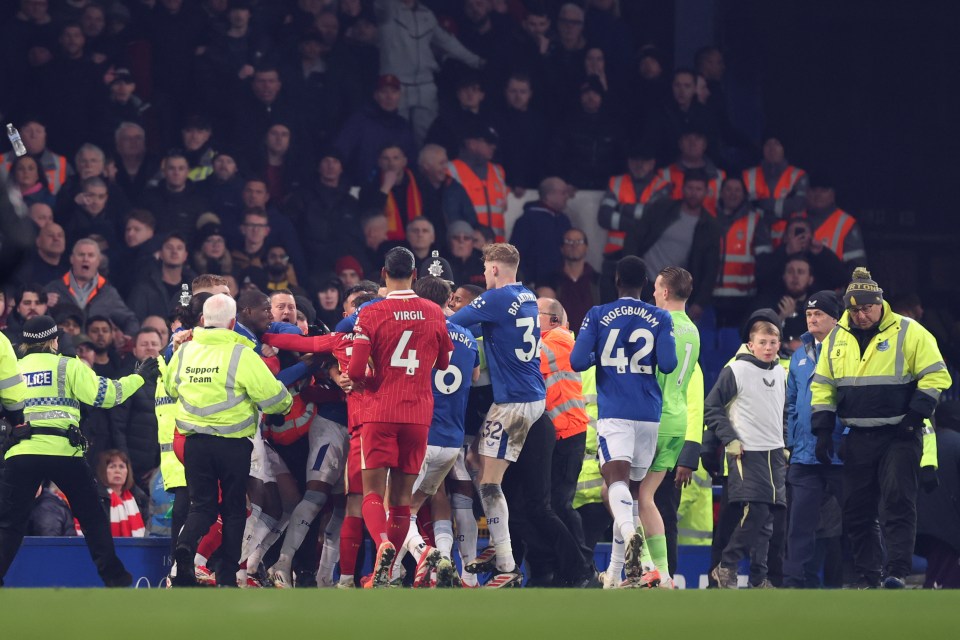 Players arguing on a soccer field after a game.