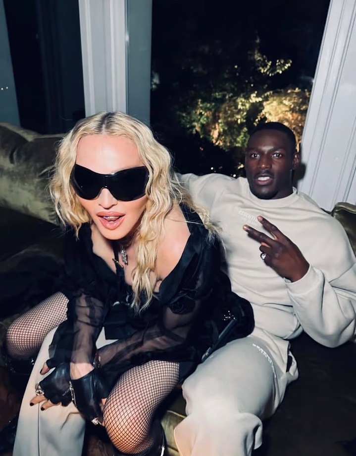 Madonna and Richard Riakporhe sitting together.