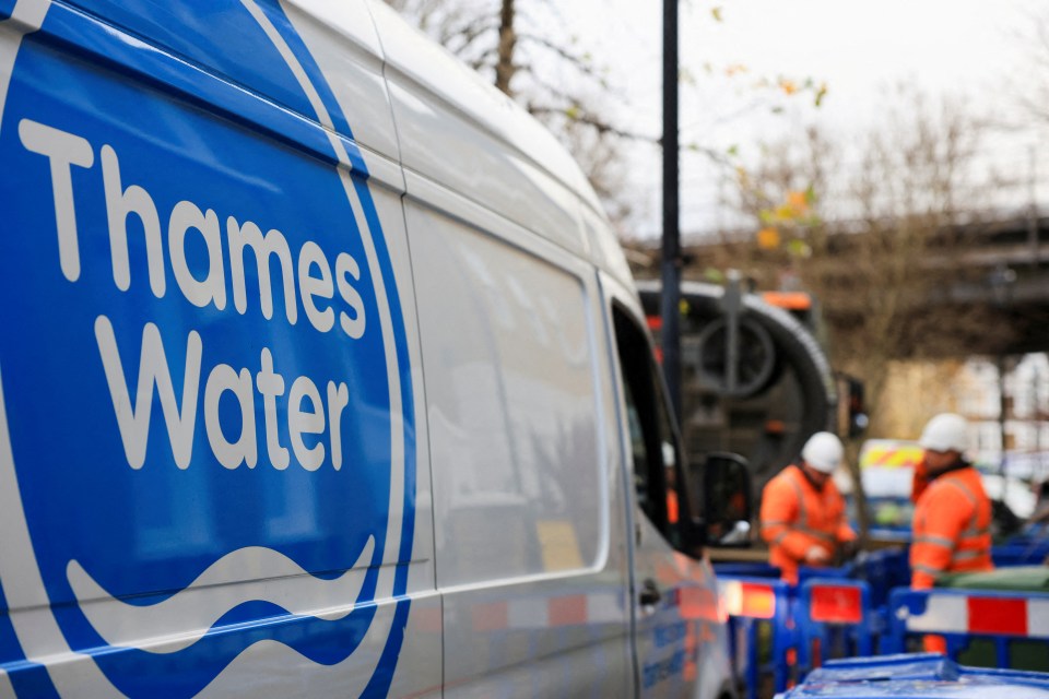 Thames Water van with workers in the background.