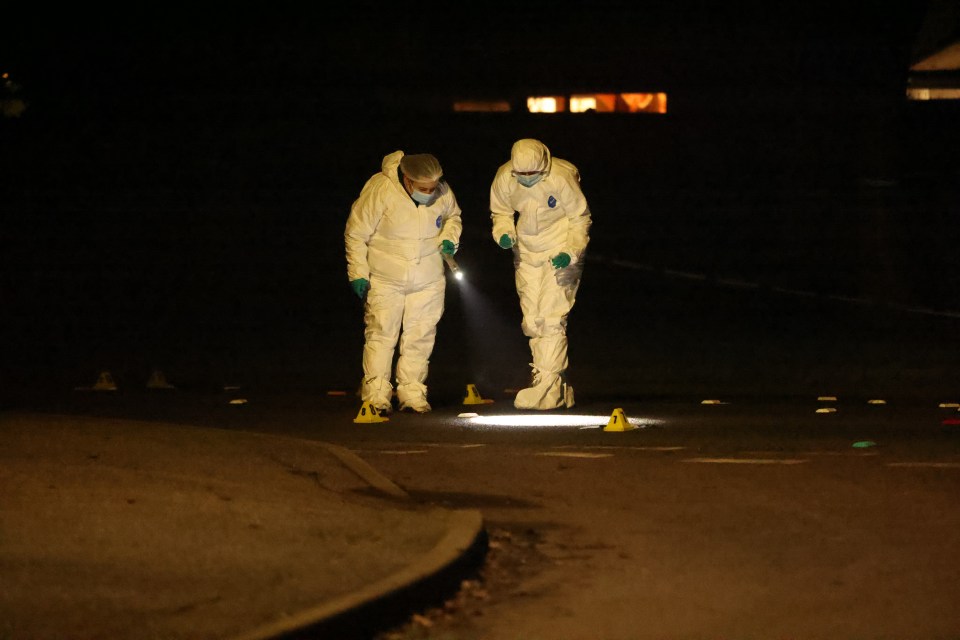 Forensic investigators at a nighttime crime scene.