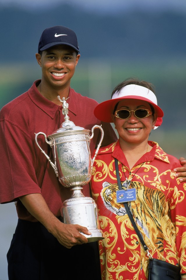 Tiger Woods holding the US Open trophy with his mother.