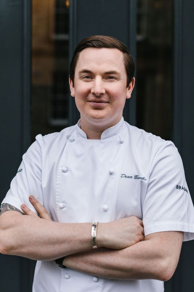 Portrait of Dean Banks in a chef's jacket.