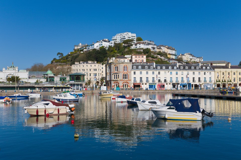 Torquay harbor with boats and buildings.