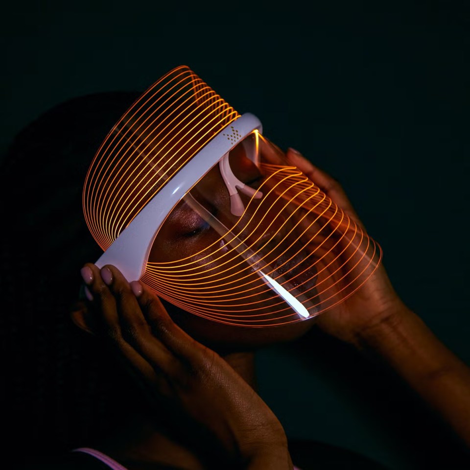 Person using an LED face mask.