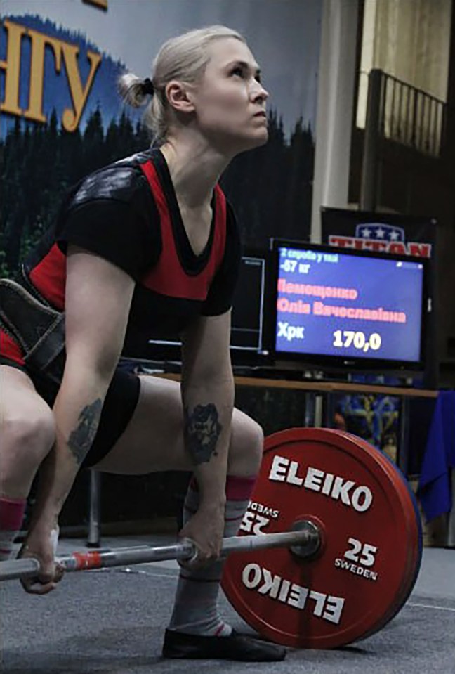 Ukrainian powerlifting champion Yulia Lemeshchenko preparing to lift weights.