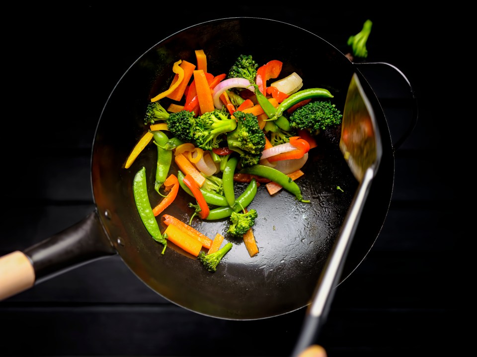 Stir-fried vegetables in a wok.