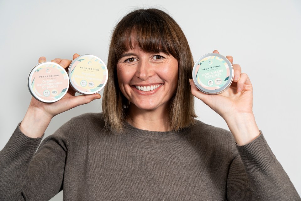 Woman holding containers of health supplements.