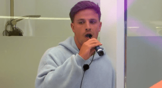 Luca from Love Island speaking into a microphone.