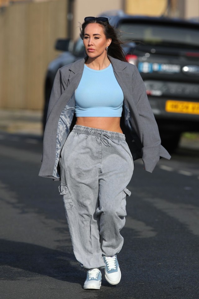 Lauryn Goodman walking down a street.