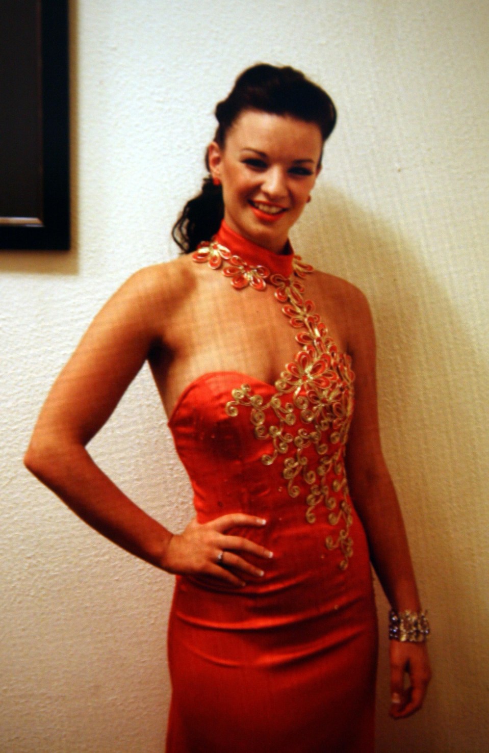 Photo of Rebecca Thomas, a dancer, wearing a red dress.