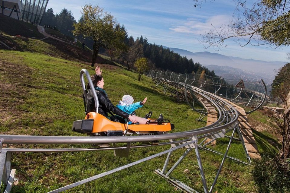 A woman and child on a mountain coaster.