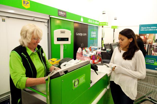 A young woman checking out at a supermarket checkout.