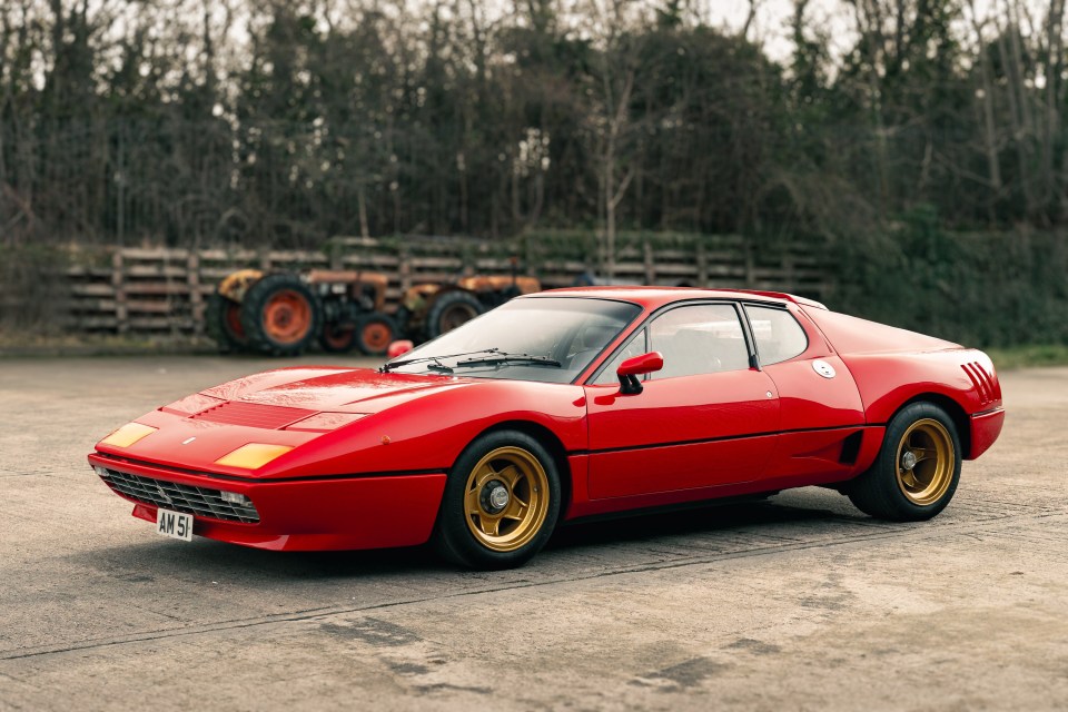 Red 1977 Ferrari 512 BB Wide Body with gold rims.