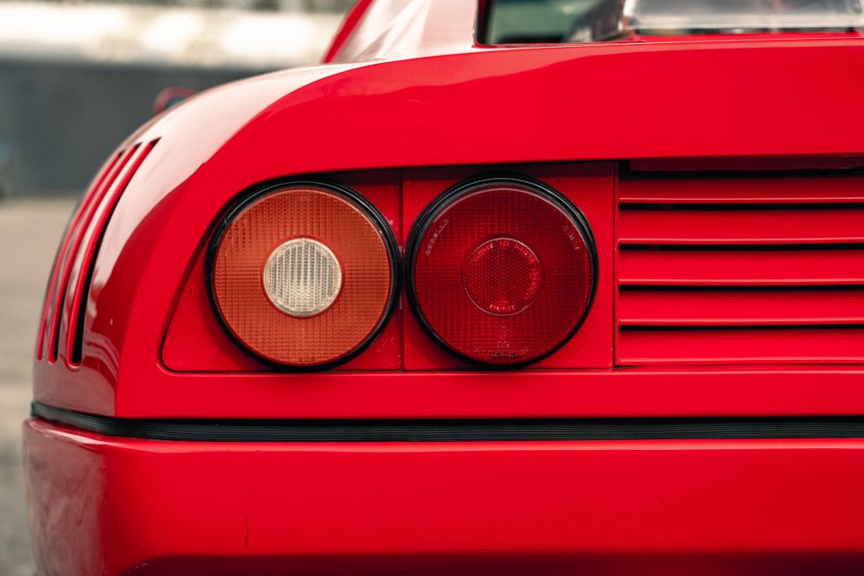 Rear view of a red Ferrari's taillights.