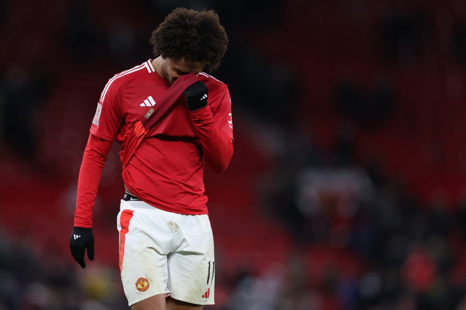 Soccer player taking off his jersey.