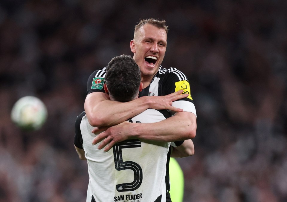 Newcastle United's Fabian Schar and Dan Burn celebrating a Carabao Cup victory.