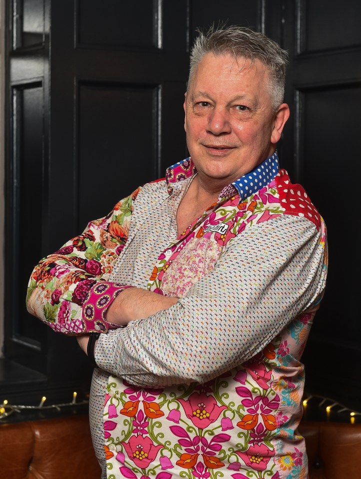 Portrait of Tony Murphy wearing a floral shirt.