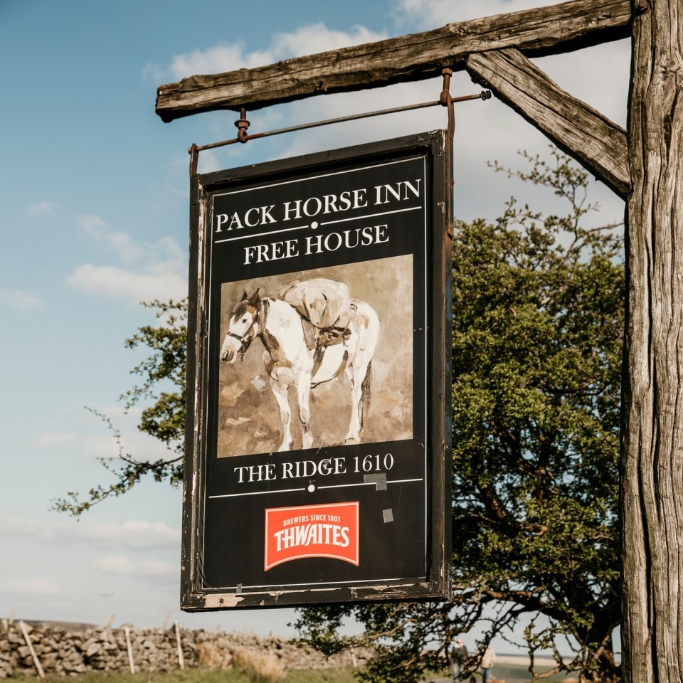 Pack Horse Inn Free House pub sign with painting of a packhorse.