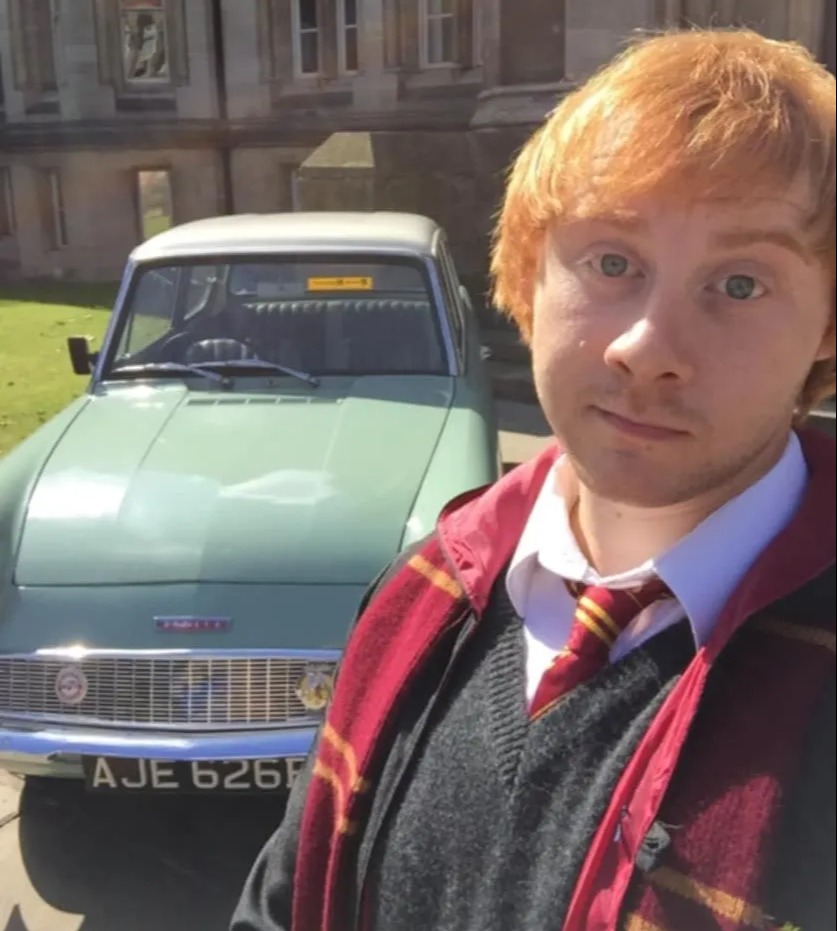 Ron Weasley lookalike Lewis Parker in front of a car.