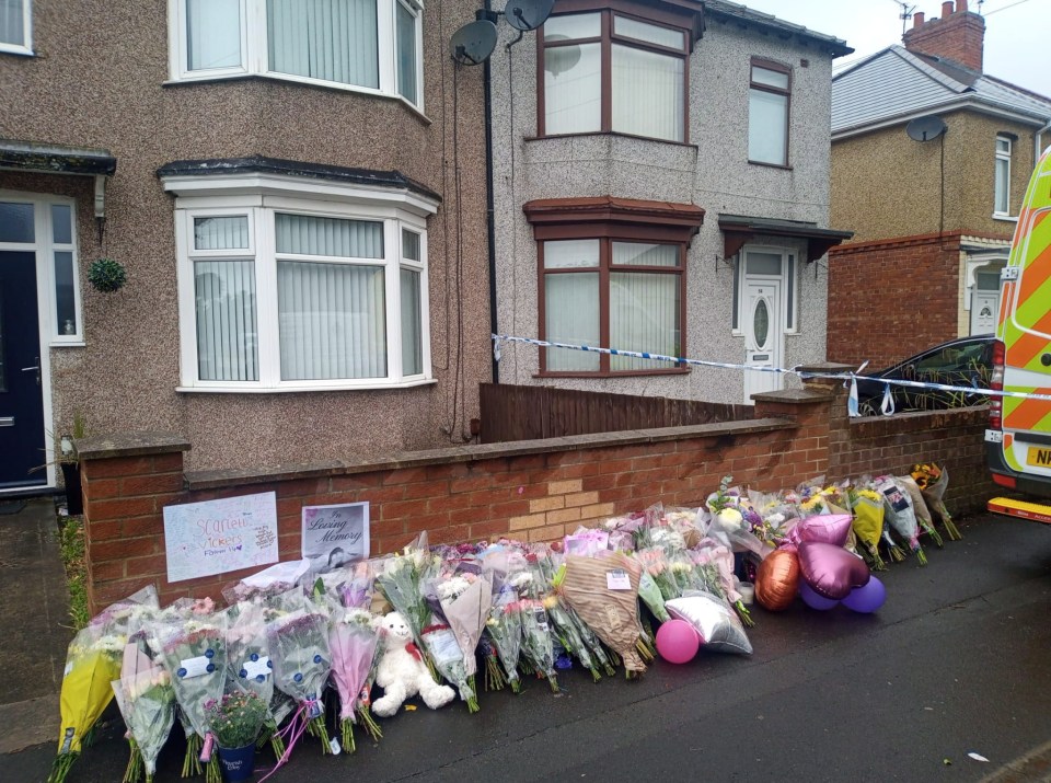 Floral tributes outside a house following a fatal stabbing.