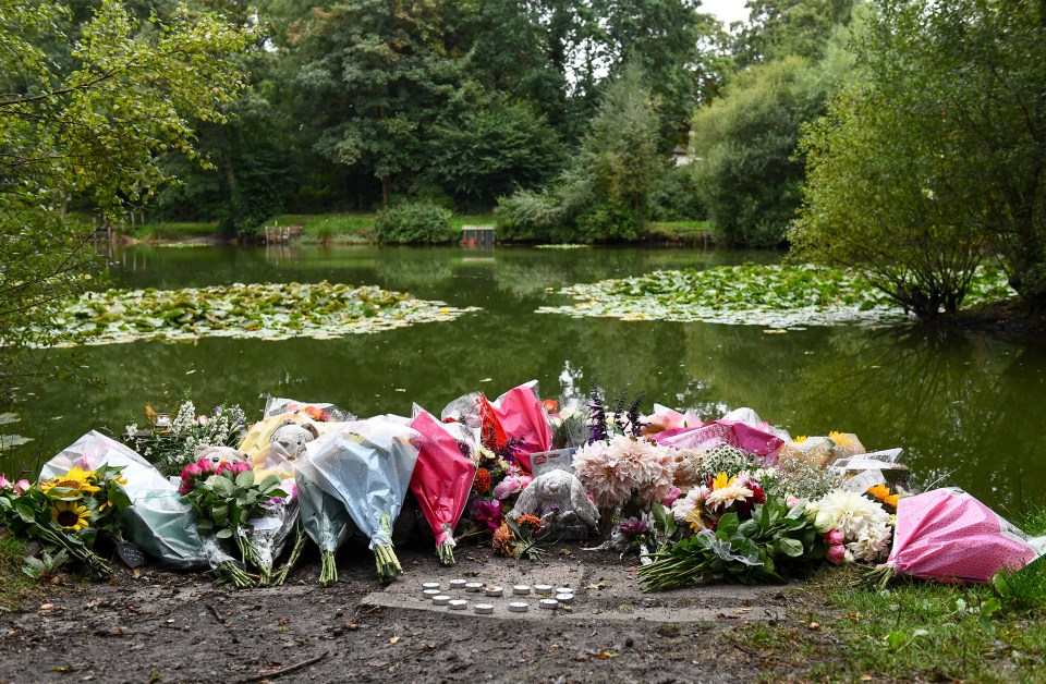 Floral tributes at a pond.