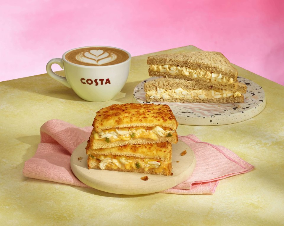 Costa Coffee new menu items: egg salad sandwich and a grilled cheese sandwich, served with a latte.