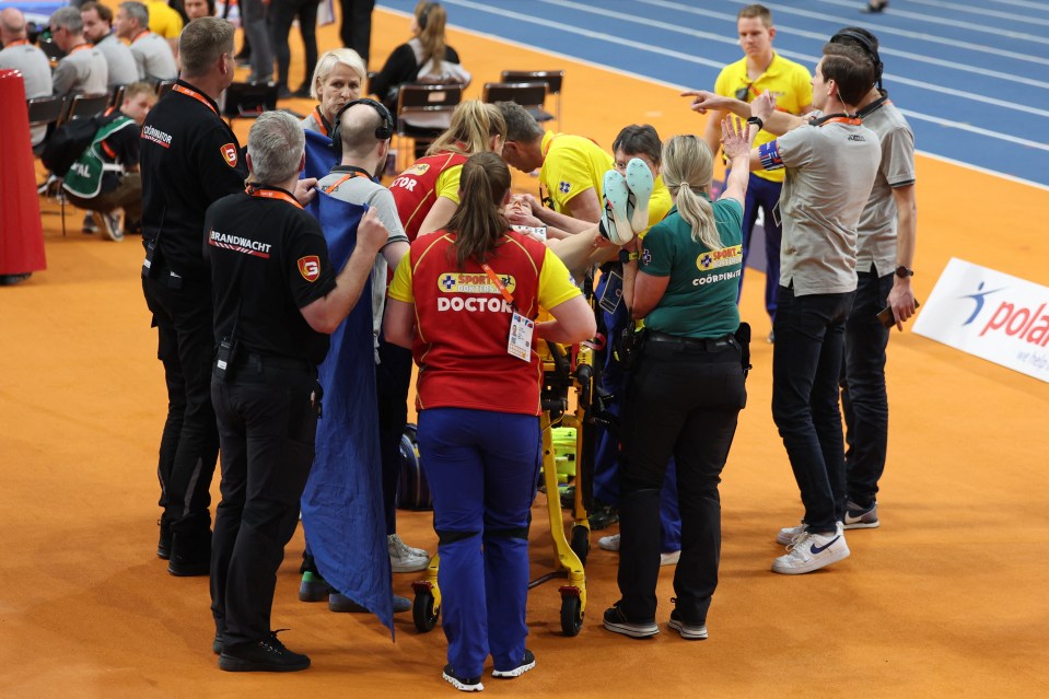 Athlete receiving medical attention after a fall.