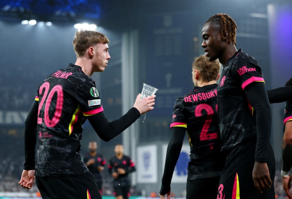 Soccer Football - Conference League - Round of 16 - First Leg - FC Copenhagen v Chelsea - Parken, Copenhagen, Denmark - March 6, 2025 Chelsea's Cole Palmer picks up a thrown cup after Enzo Fernandez scores their second goal as Chelsea's Trevoh Chalobah looks on Action Images via Reuters/Andrew Boyers