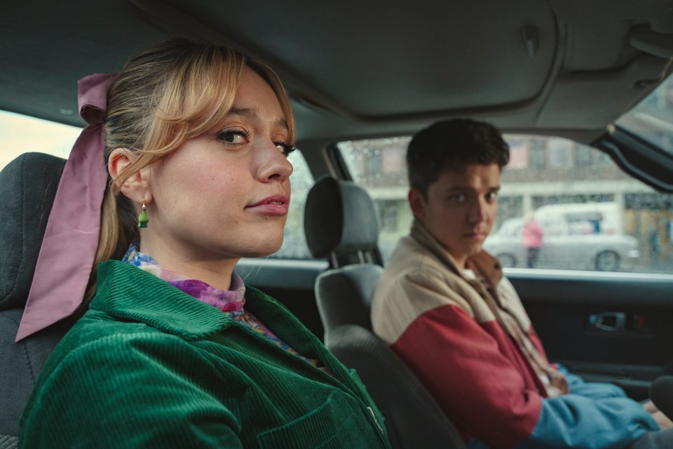 Aimee Lou Wood and Asa Butterfield in a car, from Sex Education season 4.