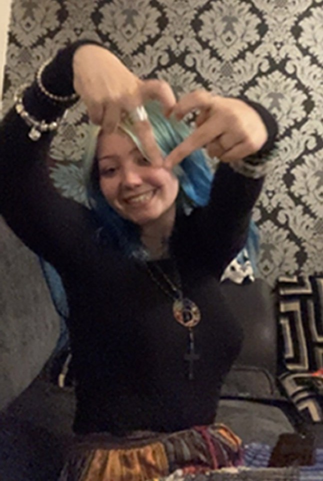 Photo of Morgan Dorsett making a heart shape with her hands.