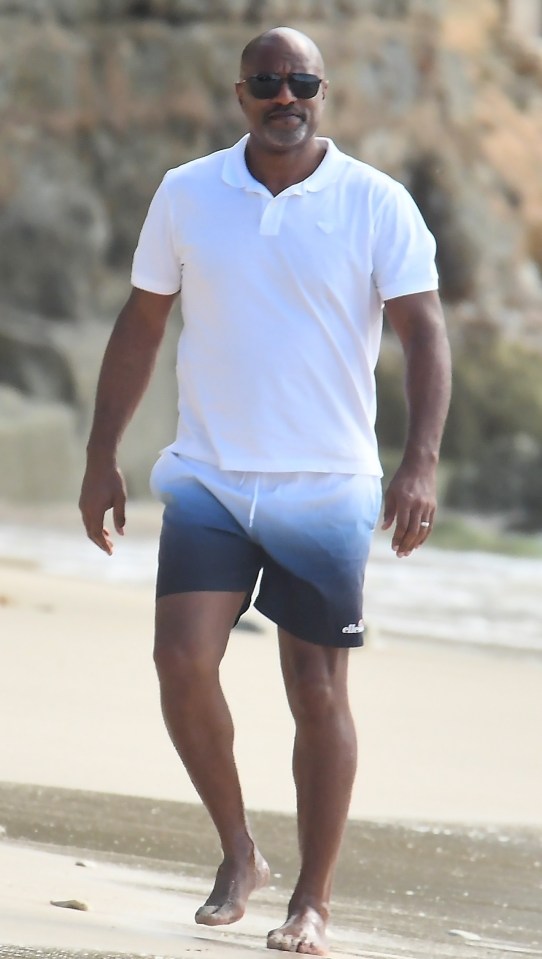 Richard Stoute walking on a beach.