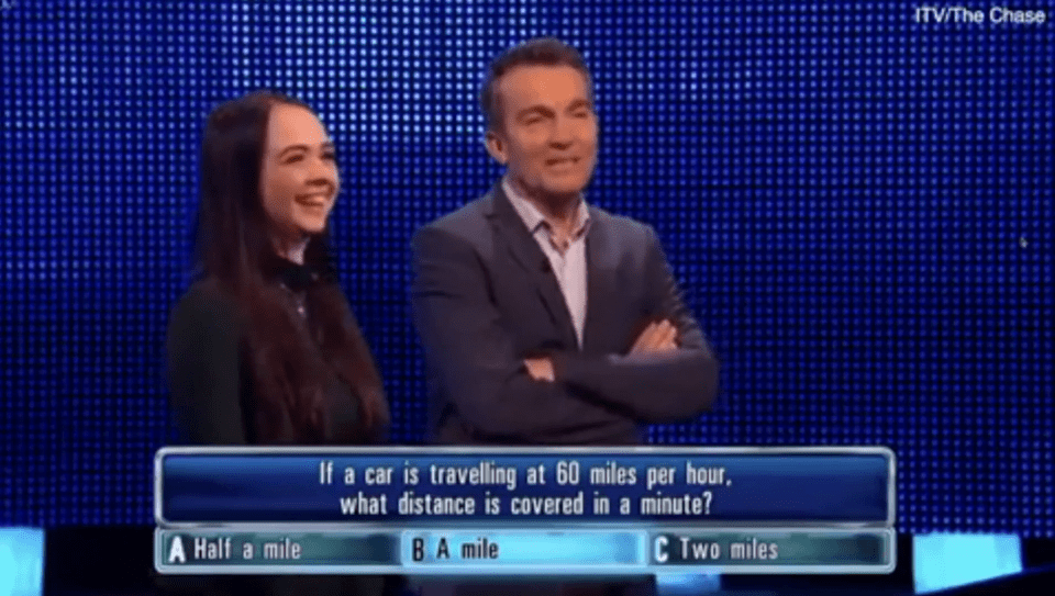 Screenshot from The Chase showing a contestant and Shaun Wallace; a question about distance, speed, and time is displayed.