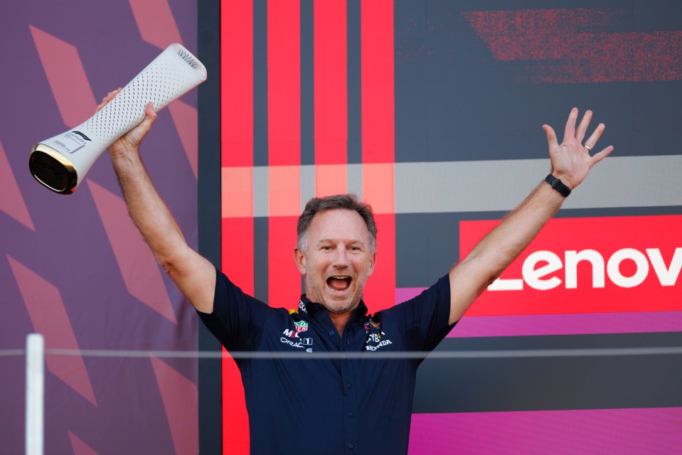 Christian Horner holding a Formula 1 trophy.