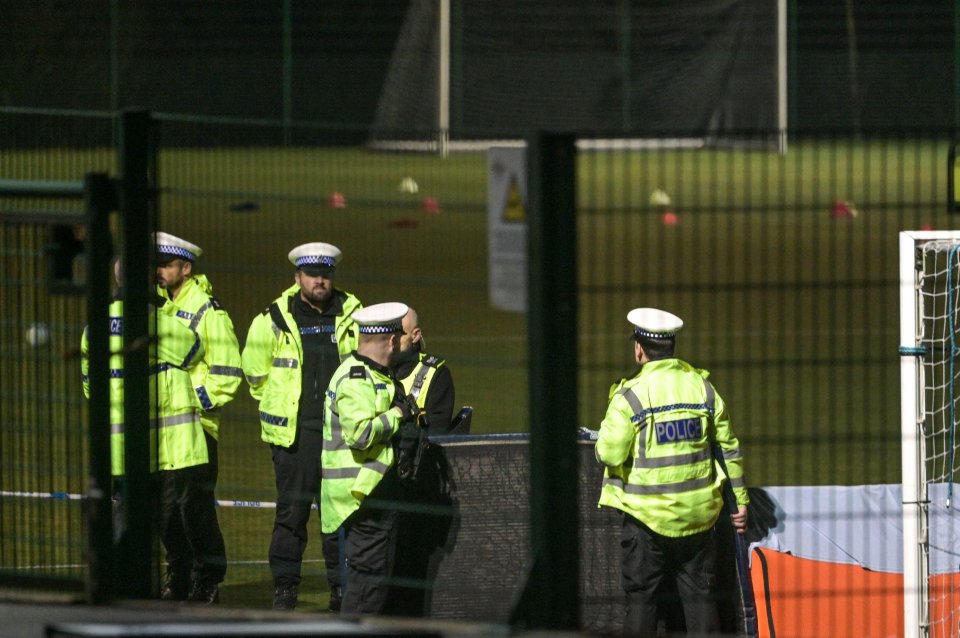 Police officers at a rugby pitch investigating a car crash that injured children.