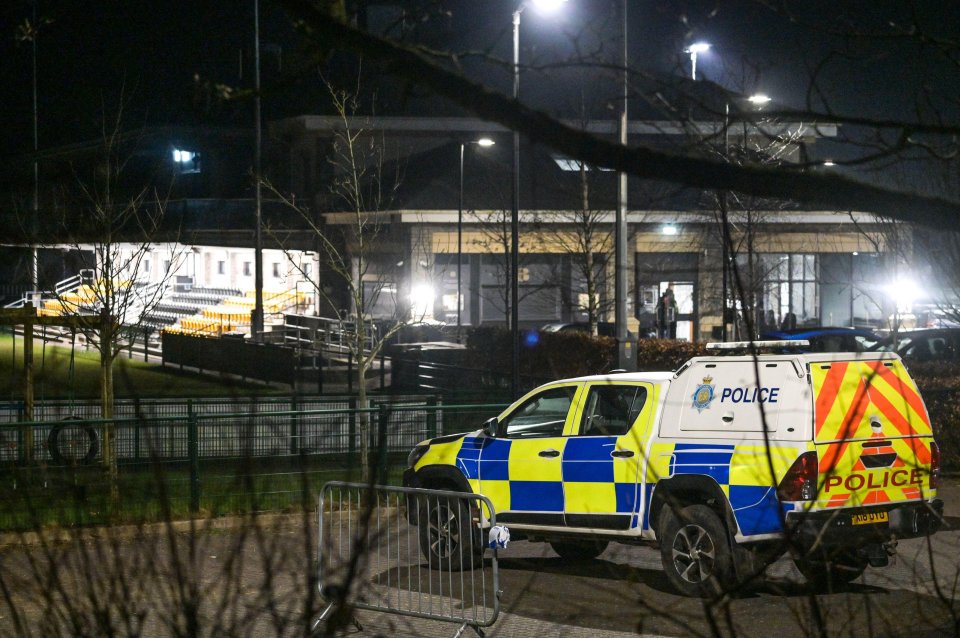 Police car at night at a rugby club following a car crash that killed a child.