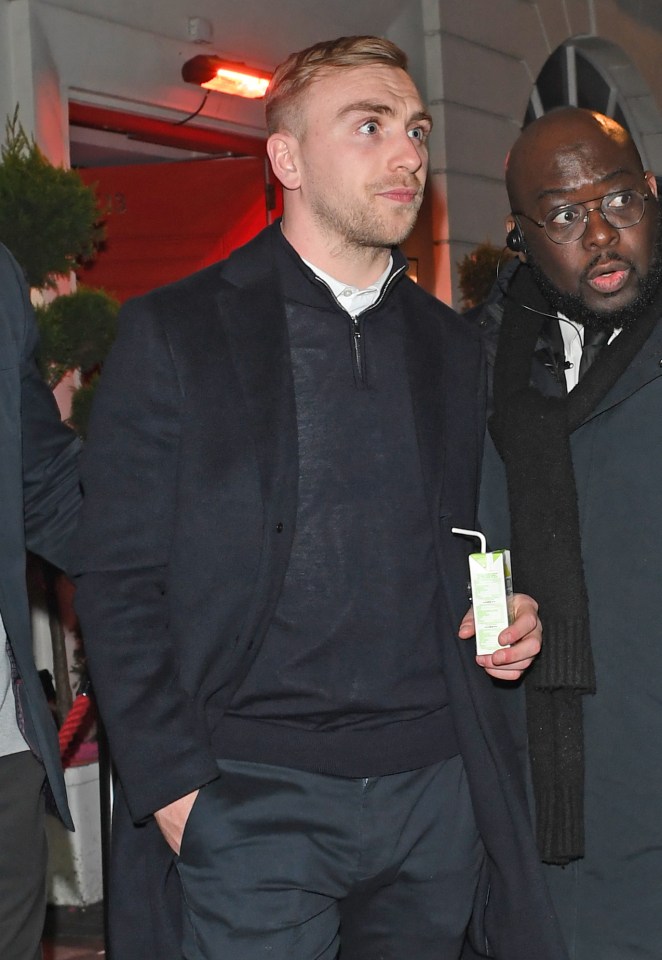 Danny Dyer escorted by a security guard after a party.