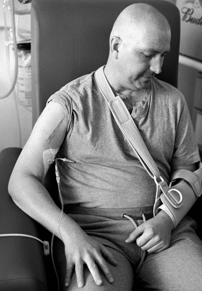 Black and white photo of Gabor Kabacs, an IT specialist, receiving medical treatment.