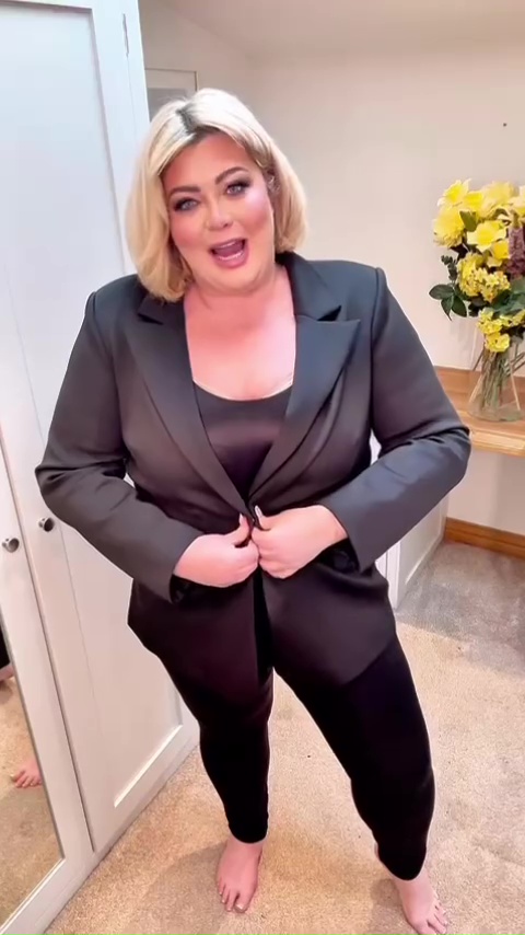 Gemma Collins modeling black shapewear and blazer.