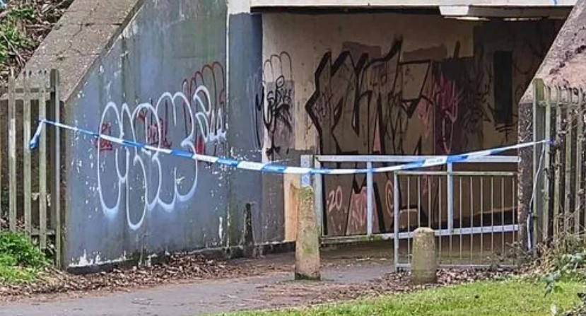 Turnberry Park underpass with graffiti and police tape.