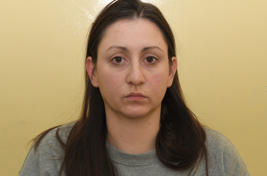 Mugshot of a woman with long brown hair.