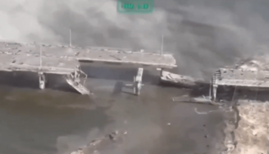 Damaged bridge section in water.