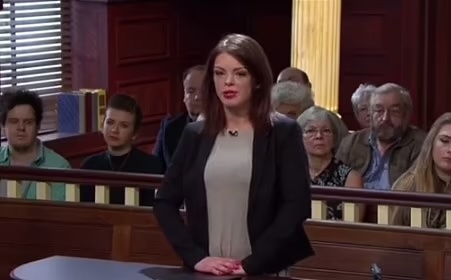 Woman testifying in a courtroom.