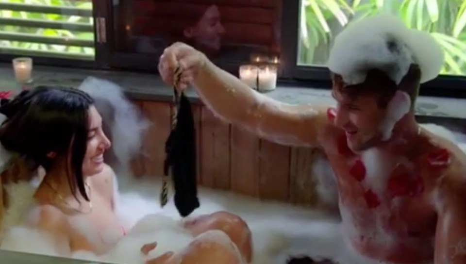 A man and woman in a bubble bath.