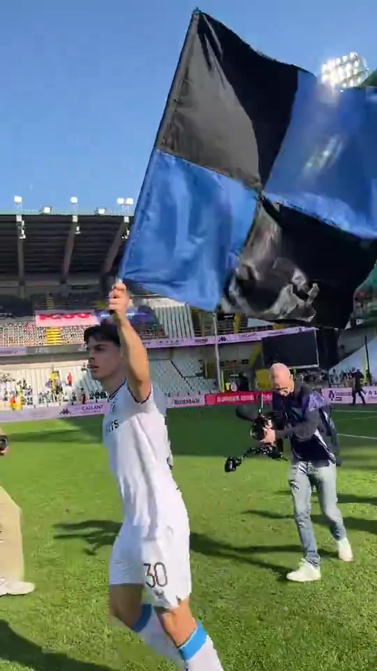 Soccer player holding a flag after a game.