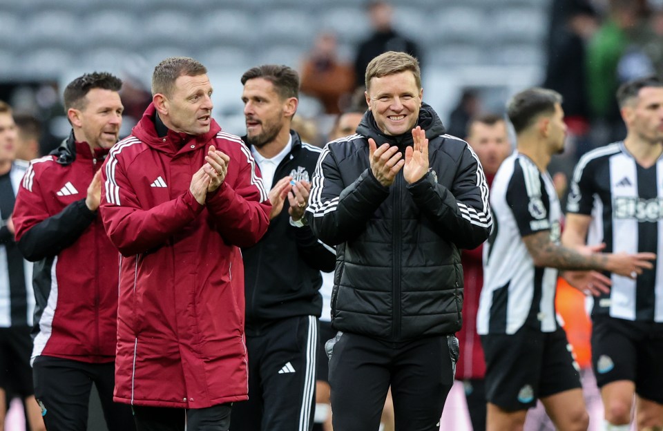 Eddie Howe, manager of Newcastle United, applauding with his coaching staff.