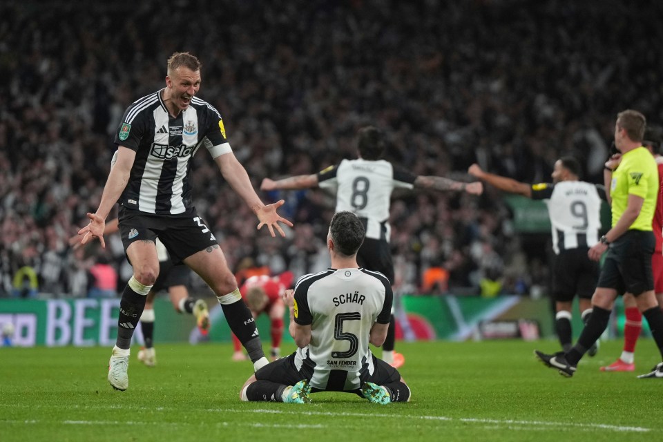 Newcastle players Dan Burn and Fabian Schär celebrating a soccer victory.