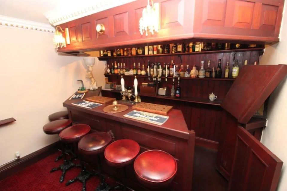 An image collage containing 1 images, Image 1 shows Interior of a home bar designed to resemble a pub