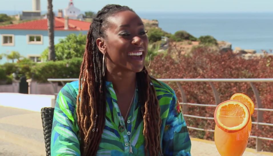 Scarlette Douglas, host of A Place in the Sun, smiles outdoors.